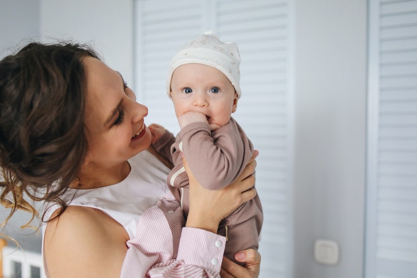 Happy mother holding baby