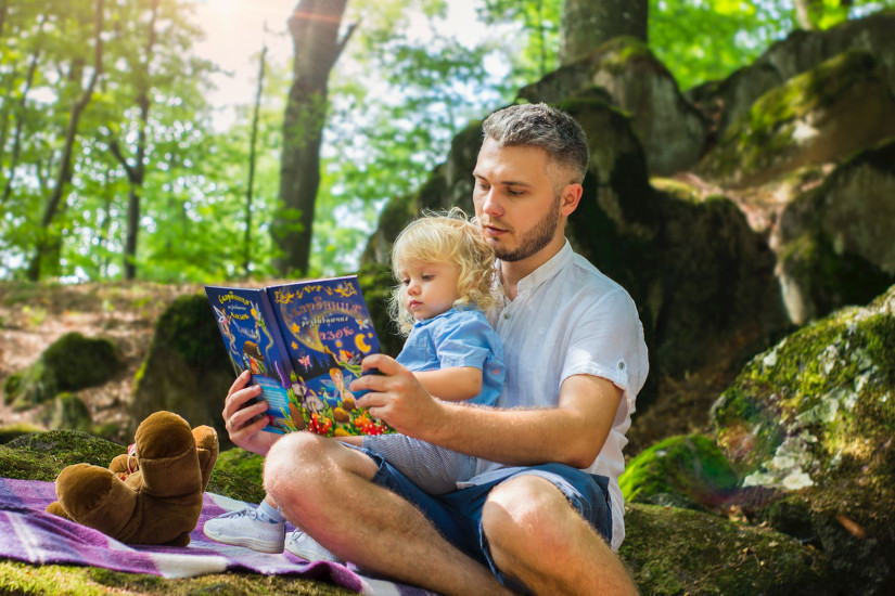 Father reading out to toddler