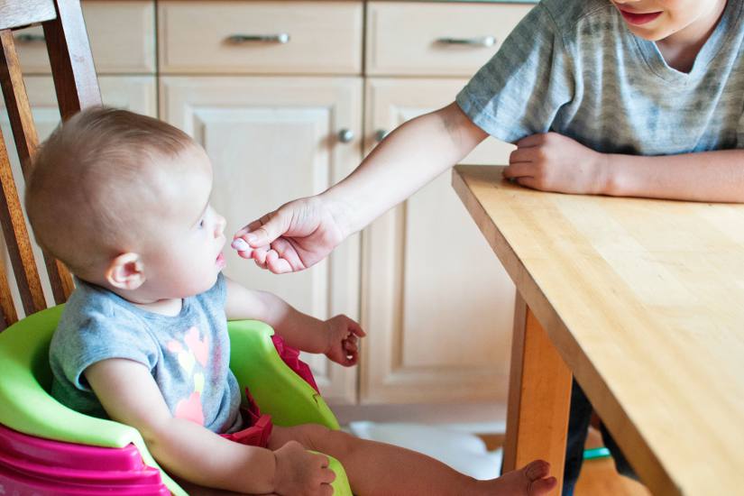 Mom trying to feed baby