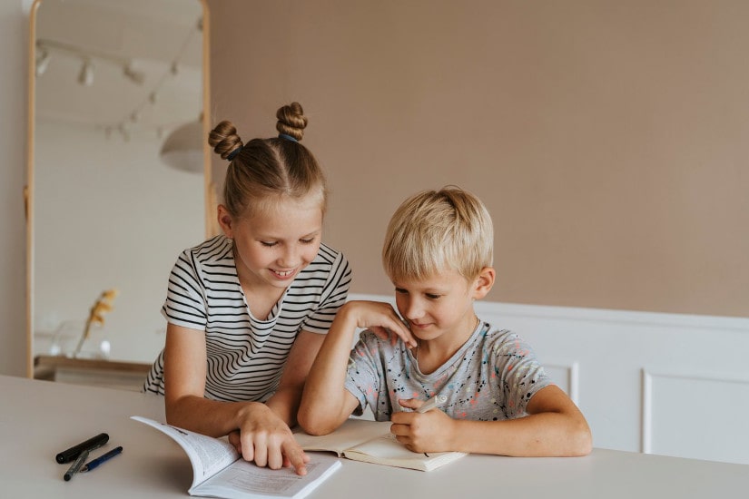 Elder sister teaching younger brother